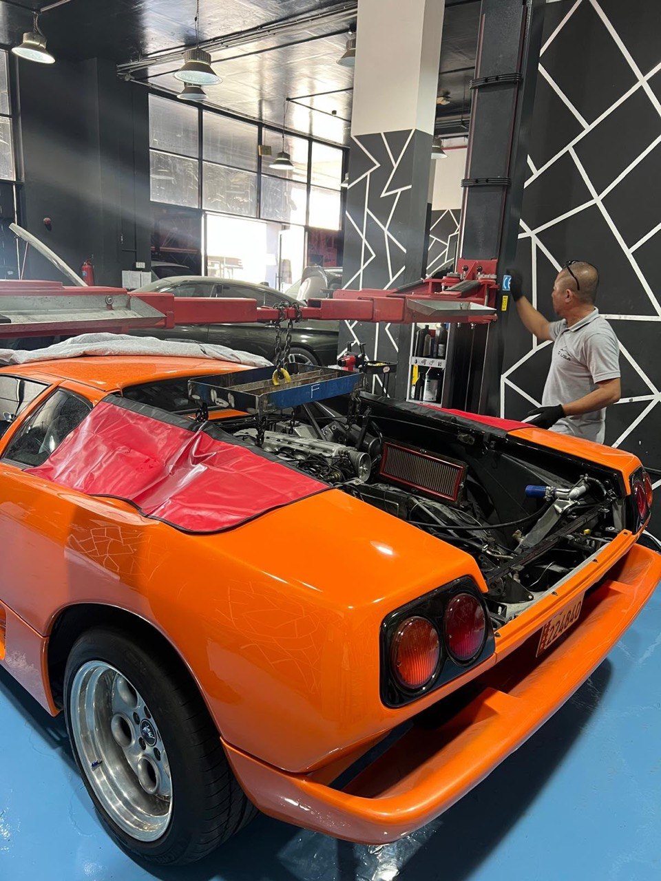 Technician working on an exposed engine bay