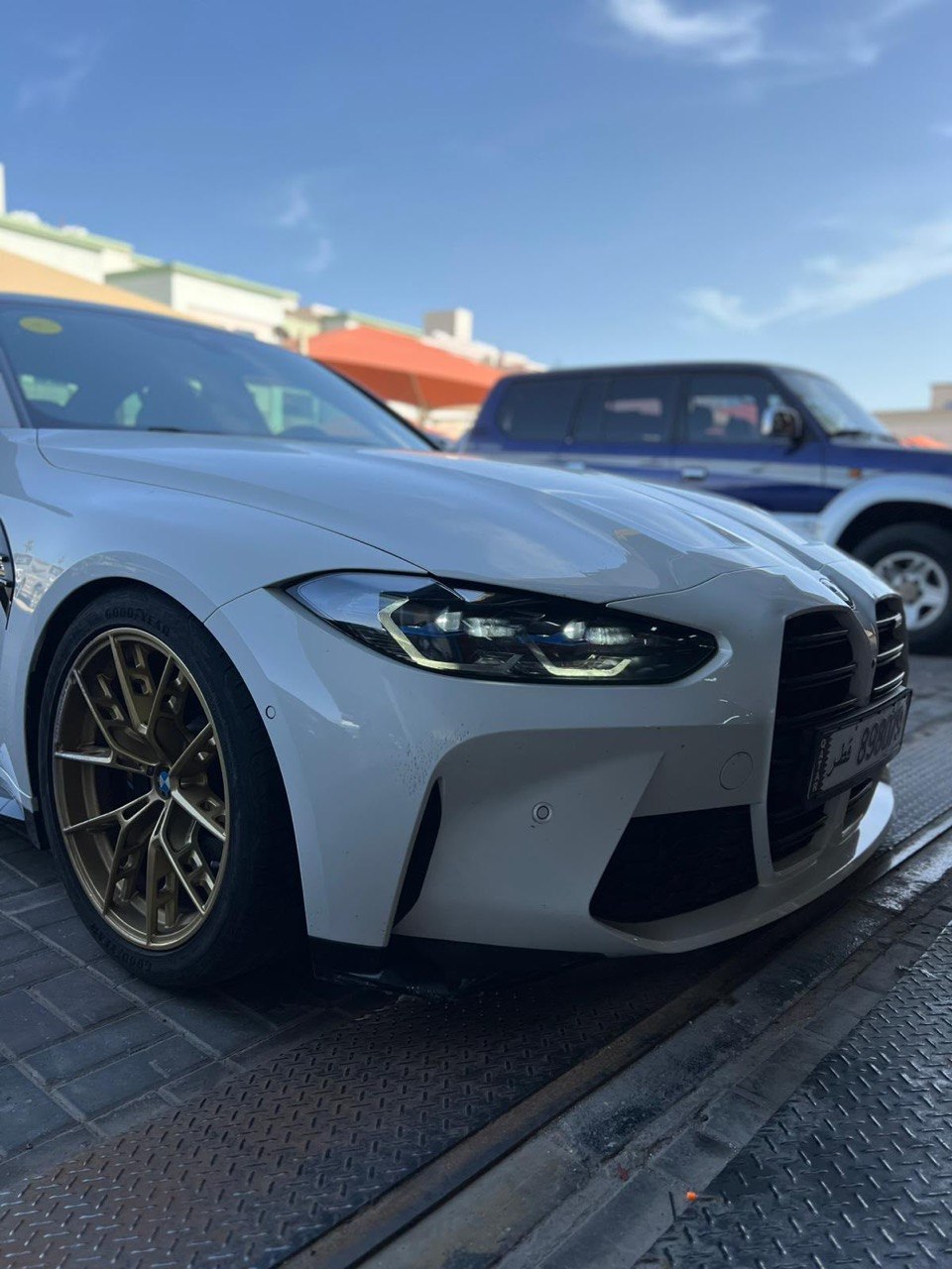 White BMW M3 with gold wheels outside Q USA Auto Shop