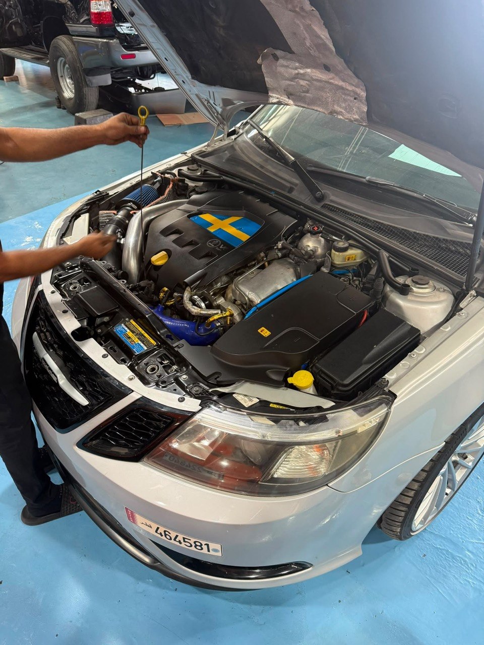Technician checking engine oil during a service