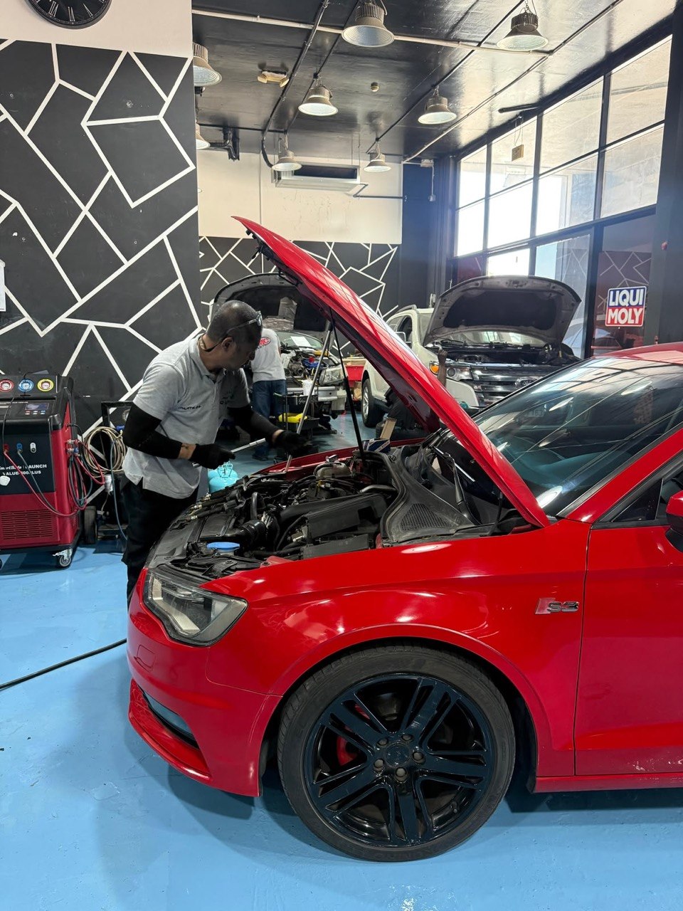 Technician running computer diagnostics on an Audi S3